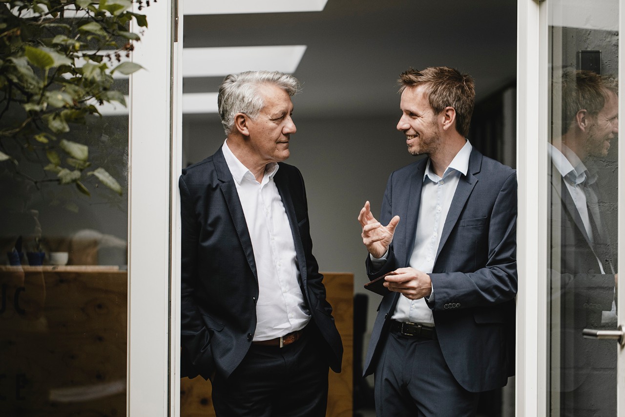 Men having a discussion by the window